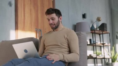 Attractive man telling a story by videoconference
