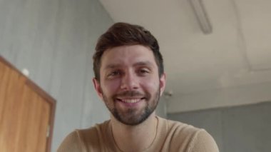 Young happy man looking at laptop by video link close-up.