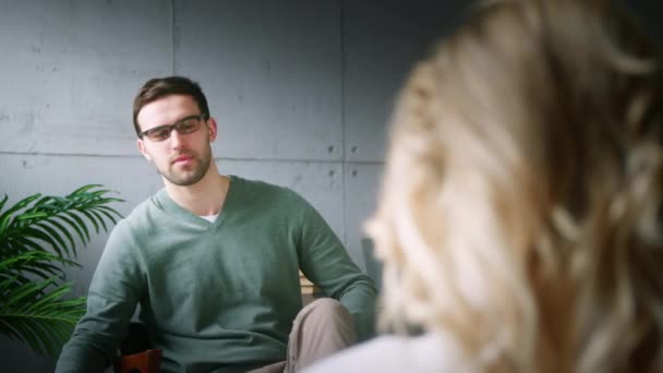 Profesional con gafas hablando con un paciente en el consultorio — Vídeos de Stock