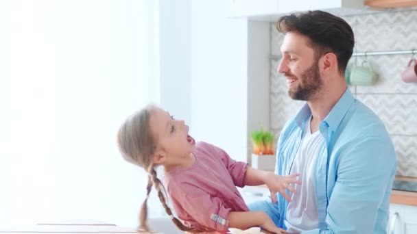 Laughing little girl with her father on Fathers Day holiday at home. Happy family at home — Stock Video