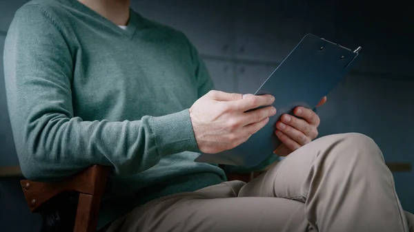 Young man with clipboard indoors — Stock Photo, Image