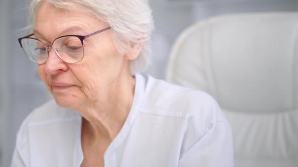 Exhausted aged woman takes off glasses thinking on life path — Stock Video