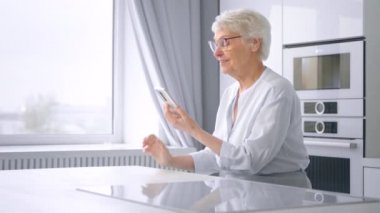 Aged mother with grey hair talks with adult children