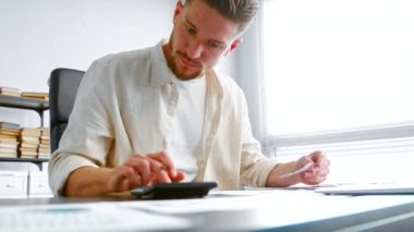 Concentrated company manager checks receipts with reports