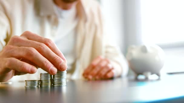 Careful guy company manager puts saved silver coins on pile — Stok video