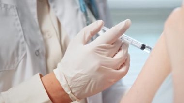Professional general practitioner injects hospital patient