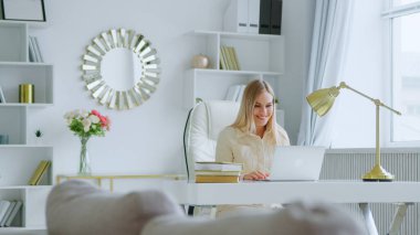Young attractive woman holding video conference remotely