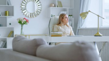 Young girl came up with an idea while sitting at work in a white room