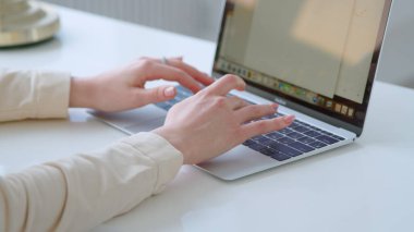 Woman typing on laptop at the desk
