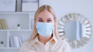 Young woman with a blue medical mask