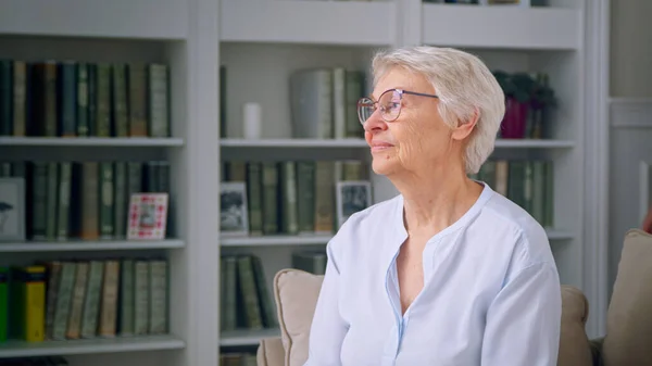 Portrait of the elderly woman in a white room — Stock Photo, Image