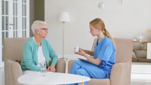 Il lavoratore medico presenta un nuovo rimedio al vecchio paziente in ufficio — Video Stock