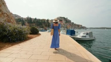 Hırvatistan 'ın Sibenik kentindeki iskelede genç bir gezgin. Yavaş çekim videosu