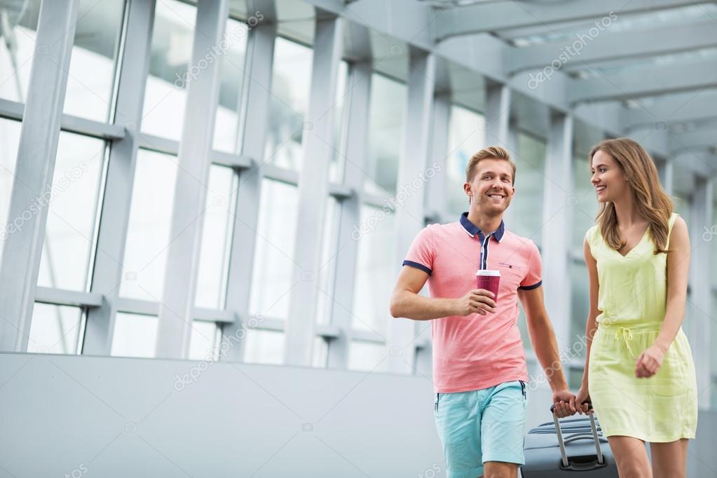 Young couple with a suitcase at the airport