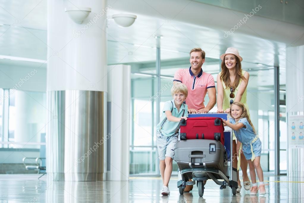 Smiling family with children at the airport