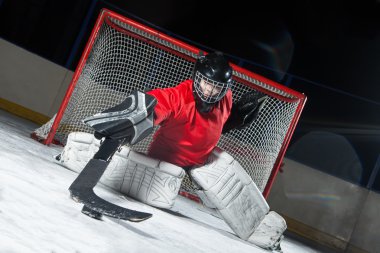 Goalie blocking a puck with stick clipart