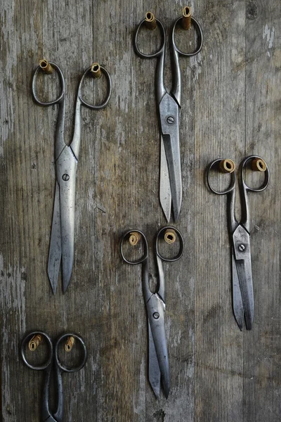 Five pairs of old scissors on a wooden — Stock Photo, Image