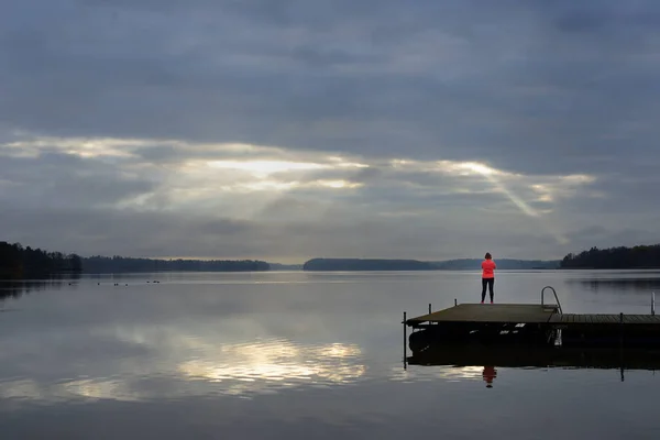Sun Rays Make Way Clouds Lake Female Silhouette Wooden Pier — стоковое фото