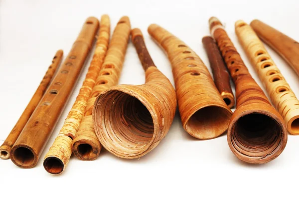 Ancient woodwind folk instruments on a white — Stockfoto