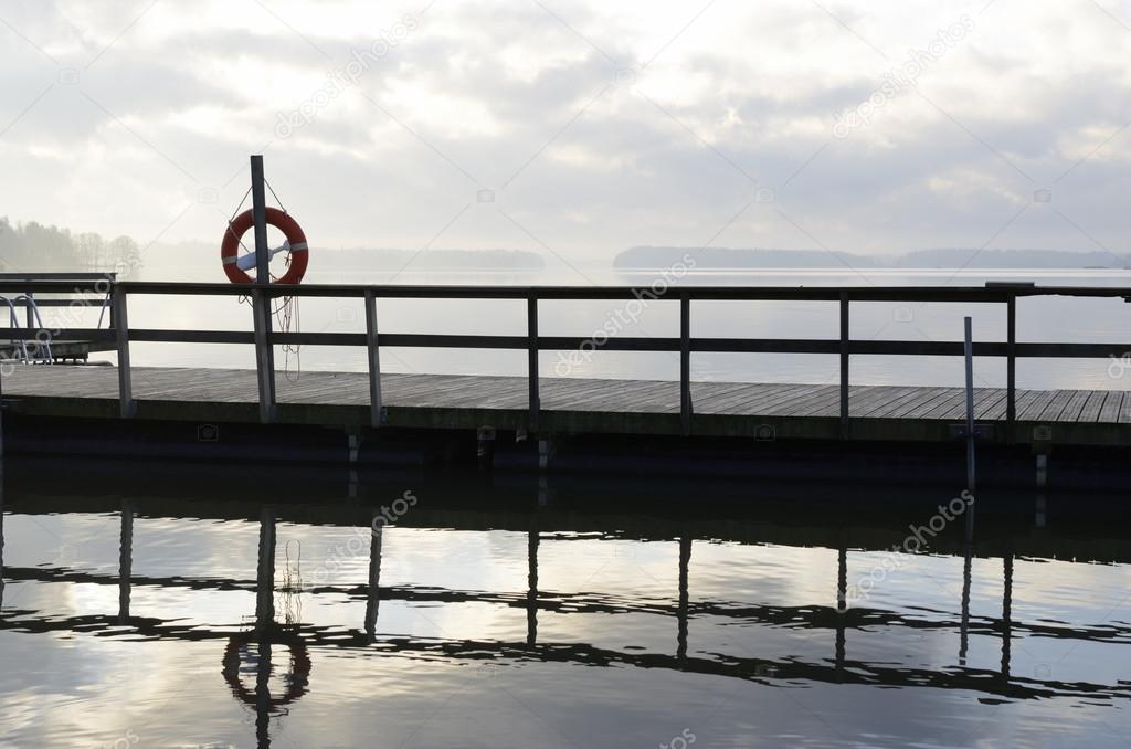 lake and wooden jetty in fog