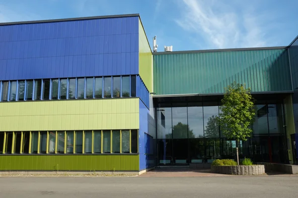 Modern building with blue and green color wall — Stock Photo, Image