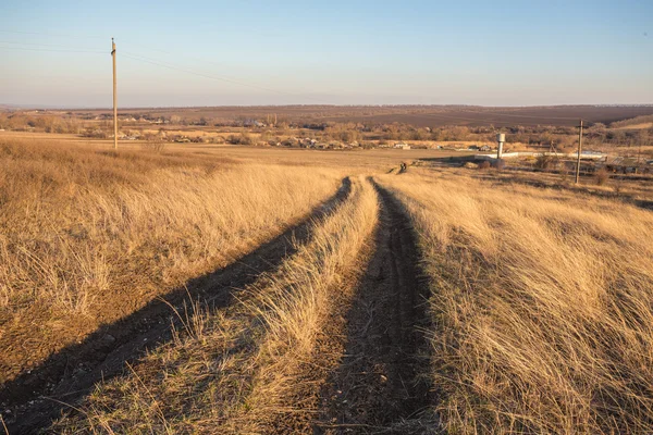 Beautiful Sunrise in the steppe over dirt road. — Stock Photo, Image