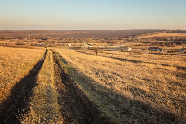 Beautiful Sunrise in the steppe over dirt road. — Stock Photo, Image