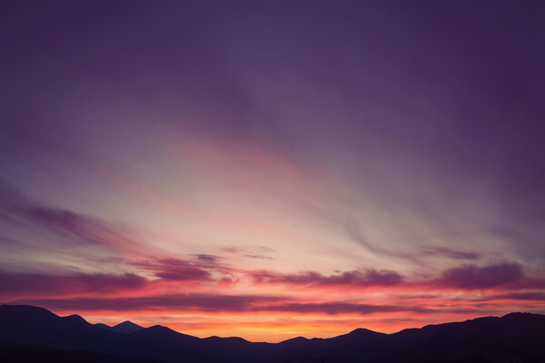 Colorful beautiful sunset over the mountain hills. Retro color.