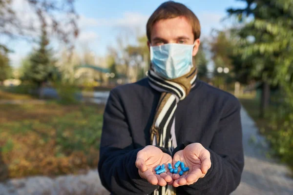 Guy Medical Mask Holds Out His Hands Pills Camera Concept — Stock Photo, Image