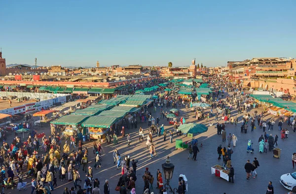 MARRAKESH, FOCCO - 2 Şubat 2017: Kimliği belirsiz insanlar gün batımında Jemaa el Fna Meydanı 'nı ziyaret ederler. Meydan UNESCO Dünya Mirası 'nın bir parçası.
