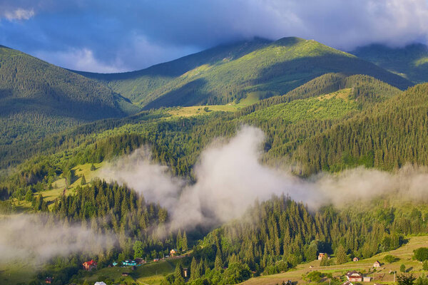 Summer landscape in mountains and the dark blue sky with clouds