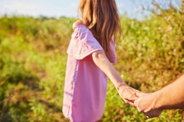 Genç bir çifti el ele tutuşurken ve parkta koşarken çekmişler. Bulanık hareket, yumuşak odaklanma