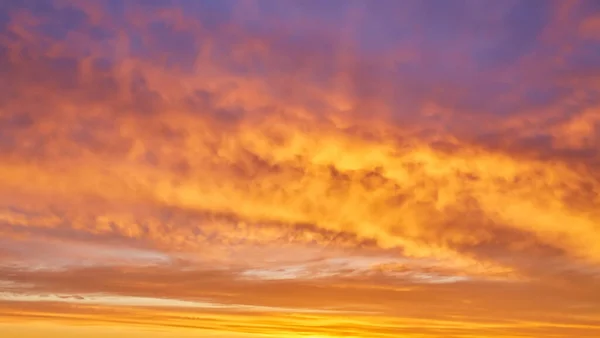 Beautiful stormy sunset sky. Cloudy abstract background. Sunset colors.