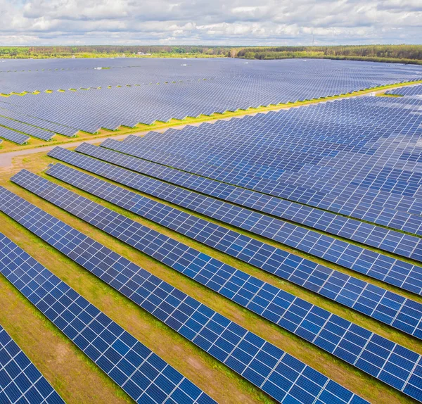 Solar panel produces green, environmentaly friendly energy from the setting sun. Aerial view from drone. Landscape picture of a solar plant that is located inside a valley