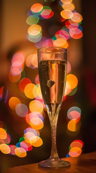 Flute of champagne in holiday setting — Stock Photo, Image