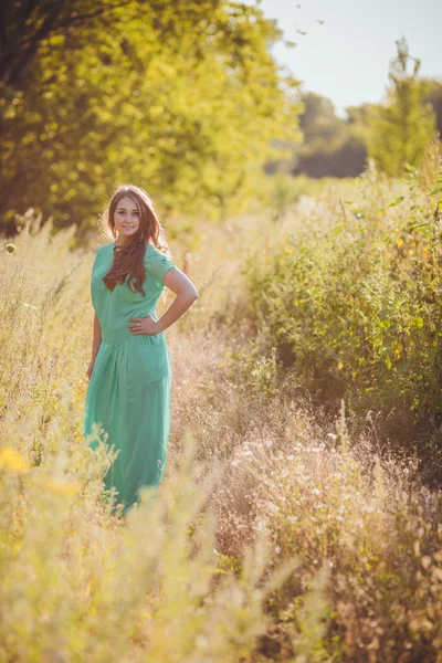 Candid skipping carefree adorable woman in field — Stock Photo, Image