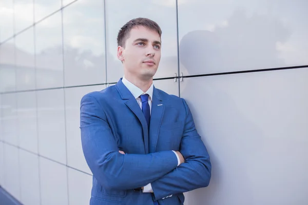 stock image Portrait of a young businessman standing over blurred background 