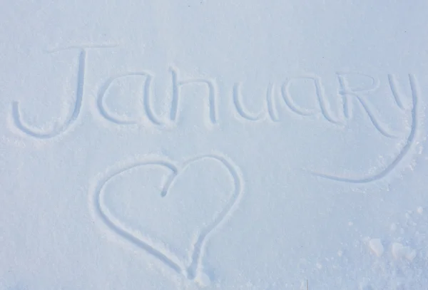 Слово Январь написано на снежном фоне — стоковое фото