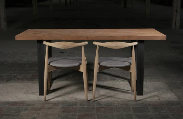 Modern wooden table in the loft interior — Stock Photo, Image