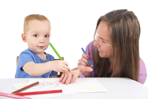 Mother and son are drawing the picture together Stock Image