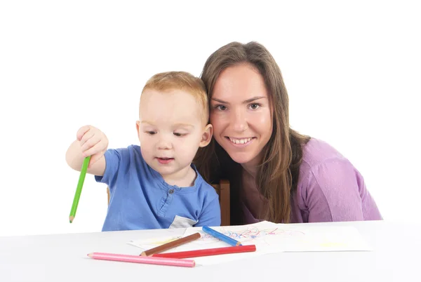 Mother and son are drawing the picture together Royalty Free Stock Images