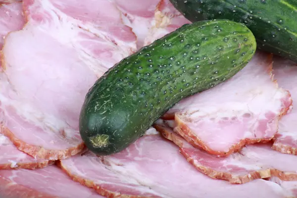 Cucumber on ham meat — Stock Photo, Image