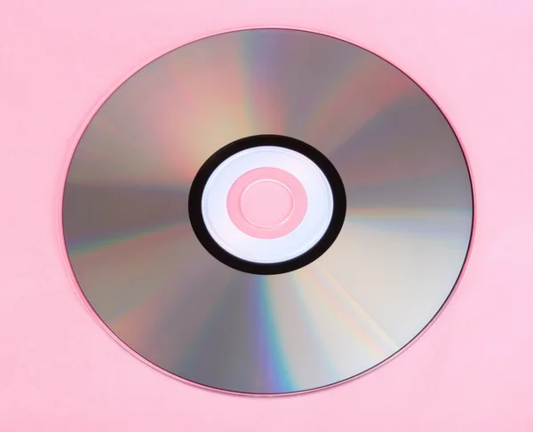 Compact disc op roze achtergrond — Stockfoto