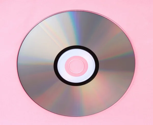 Compact disc op roze achtergrond — Stockfoto