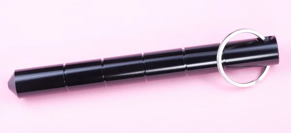 Self Defense Aluminum Alloy Stick on Pink Background