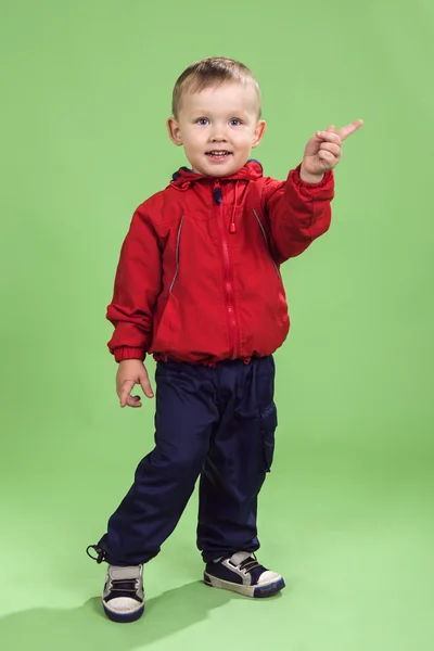 The boy of 3 years in full growth on a green background — Stock Photo, Image