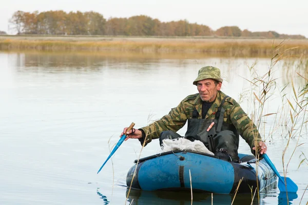 Hunter in a boat — Stock Photo, Image