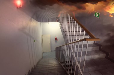 fire and an escape route in the staircase in the building  clipart