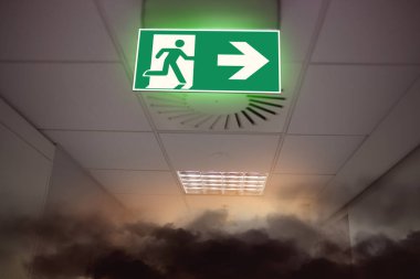 big fire and smoke in office building and emergency exit sign  clipart