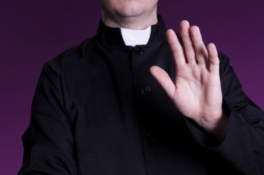 The priest at the church with raised hand clipart